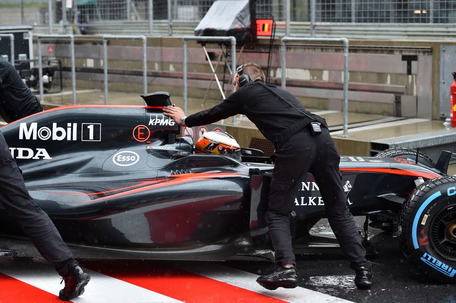 McLaren mechanics wheel Stoffel Vandoorne back into the garage
