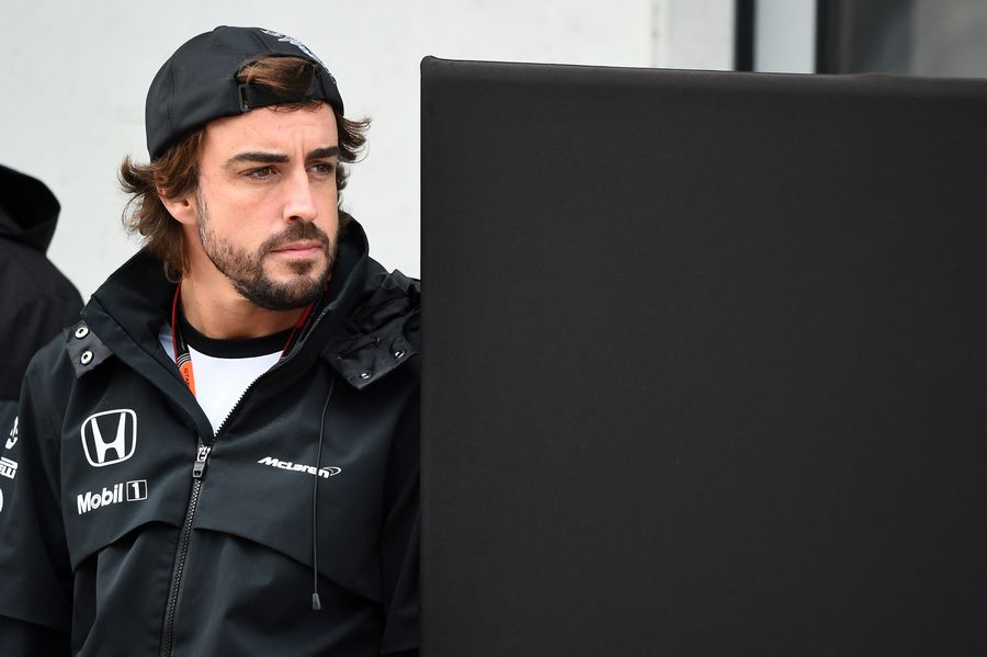 Fernando Alonso watches the session from the pit