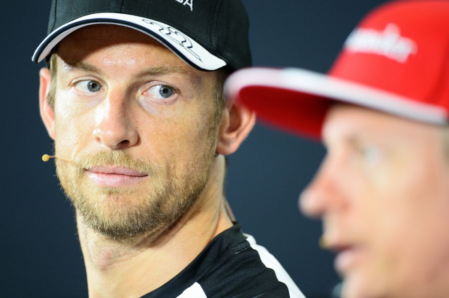 Jenson Button looks on Kimi Raikkonen during the Thursday press conference