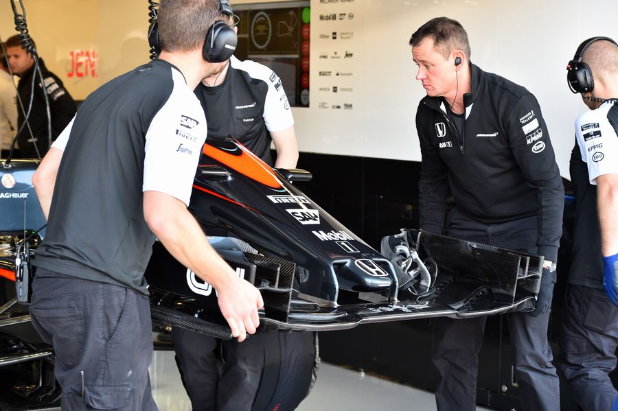 McLaren mechanics put front wing onto MP4-30