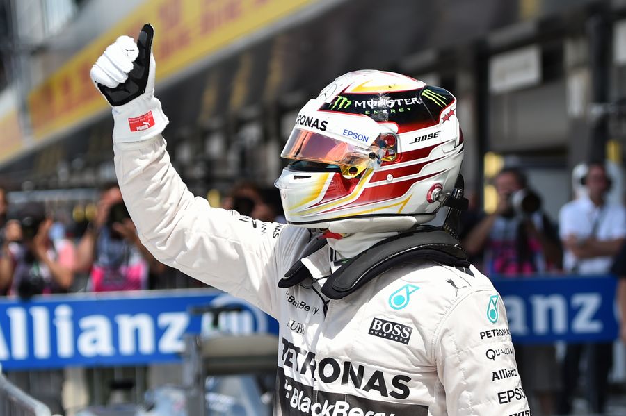 Lewis Hamilton celebrates taking pole position in his home race