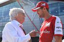 Bernie Ecclestone talks with Sebastian Vettel in the paddock