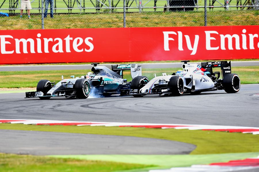 Lewis Hamilton tries to pass Felipe Massa after losing the lead