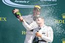 Lewis Hamilton and Nico Rosberg enjoy their champagne celebrate on the podium