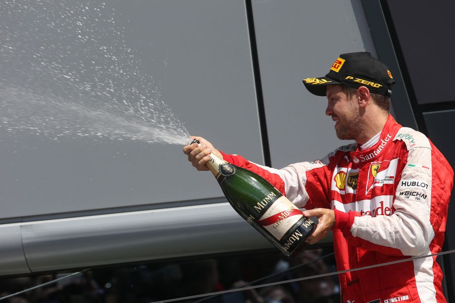 Sebastian Vettel celebrates with the champagne on the podium
