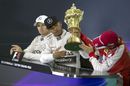 Sebastian Vettel takes a look at Lewis Hamilton's trophy during the press conference