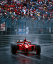 Michael Schumacher picks a line through the spray on his way to winning the race