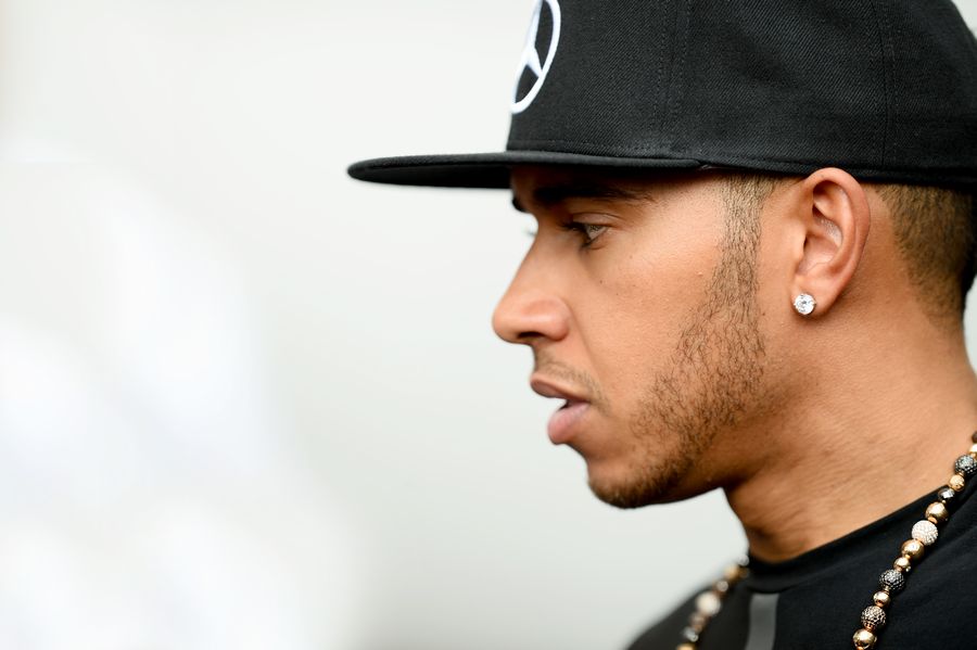 Lewis Hamilton looks on in the paddock