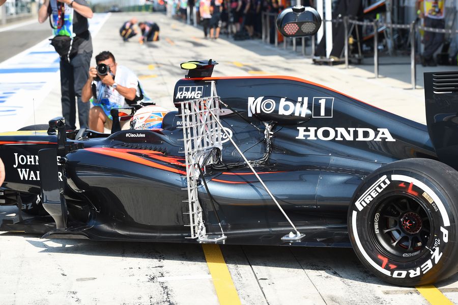 Jenson Button pulls out of the McLaren garage with aero sensor