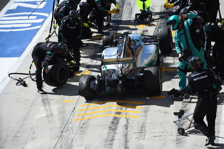Nico Rosberg enters the pits with a punctured rear tyre