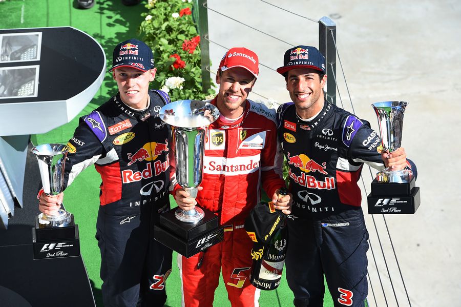 Top 3 pose with the trophies on the podium