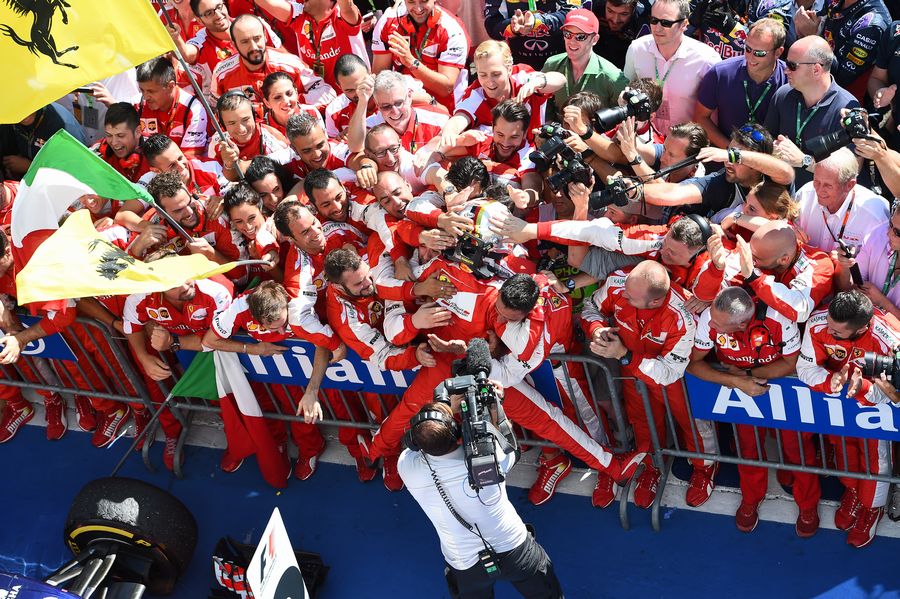 Sebastian Vettel celebrates his win in parc ferme with the team