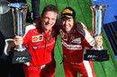 Sebastian Vettel and James Allison celebrate on the podium with the trophies