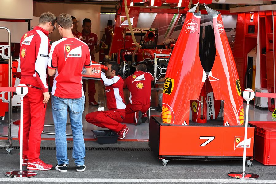 Sebastian Vettel discuss something with Ferrari engineer