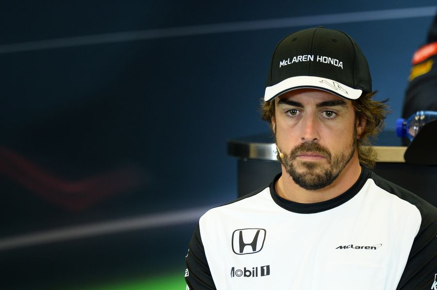 Fernando Alonso looks on in the press conference