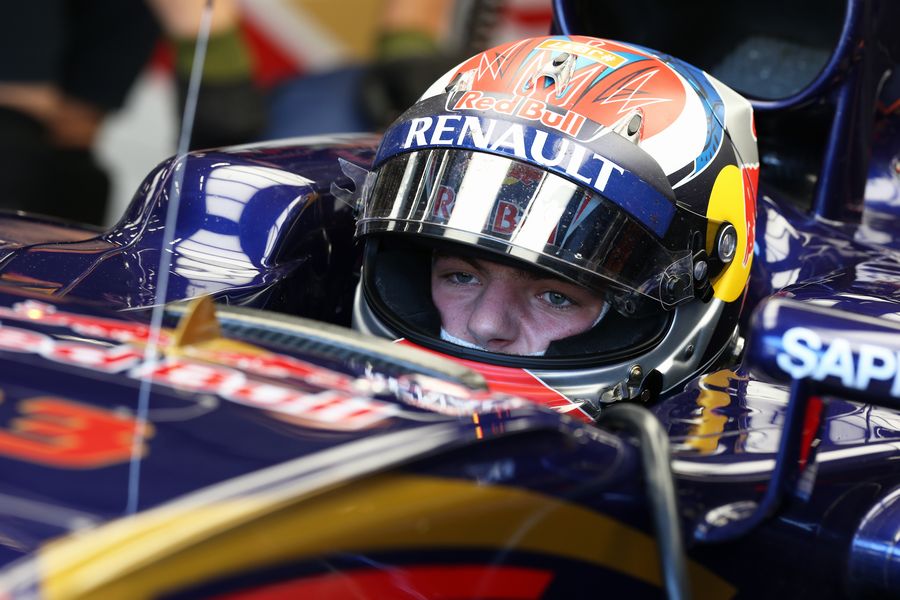 Max Verstappen sits in the Toro Rosso cockpit in the garage