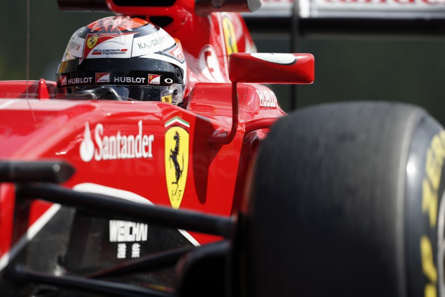 Kimi Raikkonen cranks on the steering lock in the Ferrari
