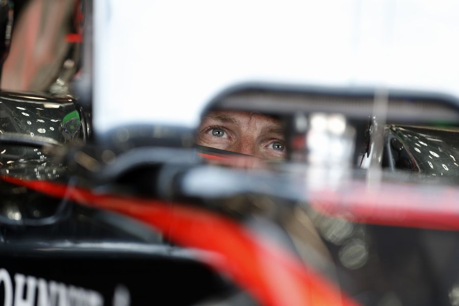 Jenson Button looks on in the cockpit