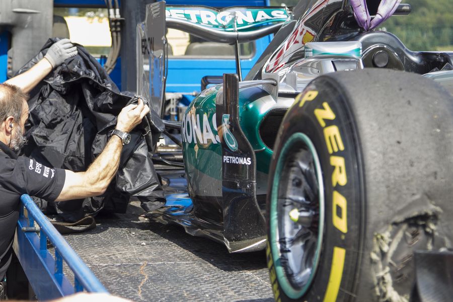 Nico Rosberg's damaged Mercedes returns to the pits