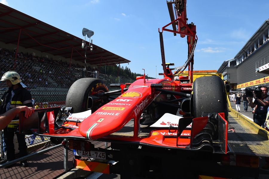 Kimi Raikkonen's Ferrari returns on a flatbed truck after a technical issue on track