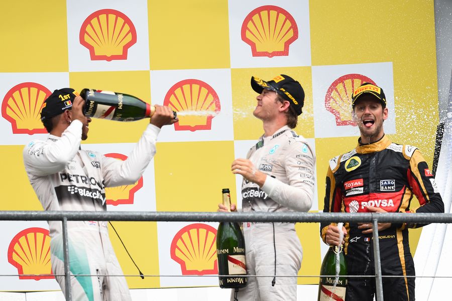 Lewis Hamilton and Nico Rosberg enjoy their champagne celebrate on the podium