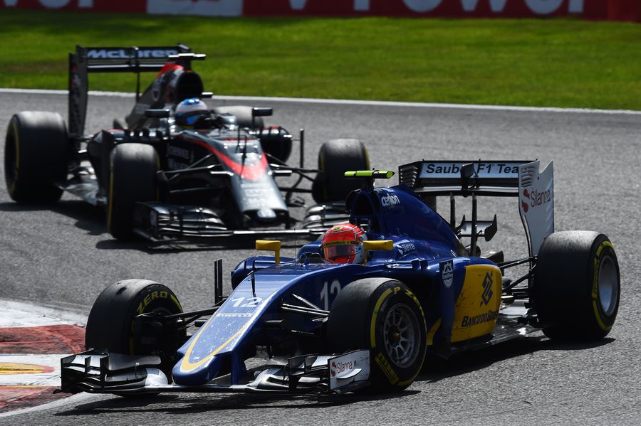 Felipe Nasr battles a position with Fernando Alonso