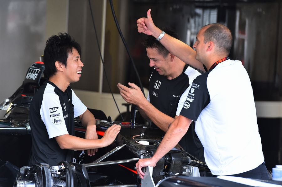 McLaren engineers chat in the garage