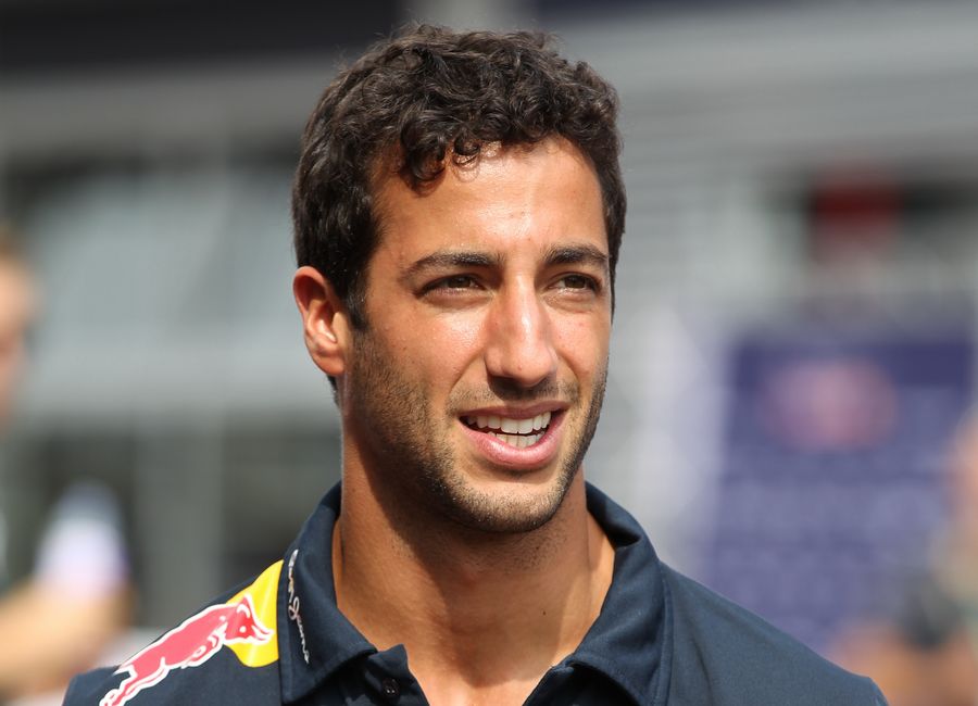 Daniel Ricciardo walks through the paddock