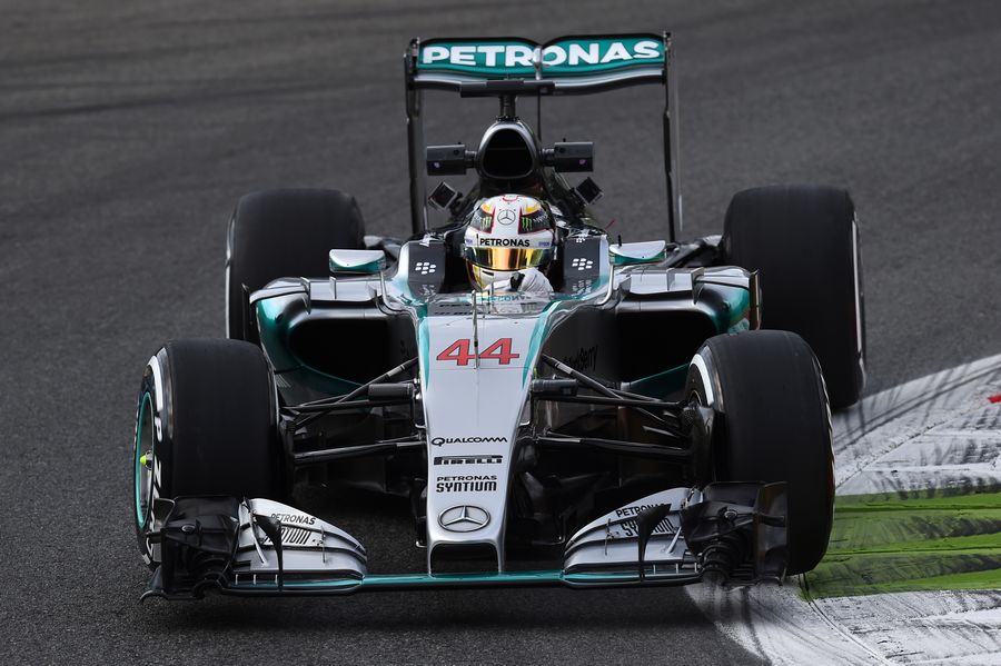Lewis Hamilton cranks on the steering lock in the Mercedes