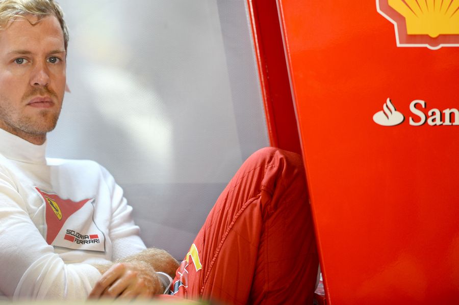 Sebastian Vettel looks on in the garage