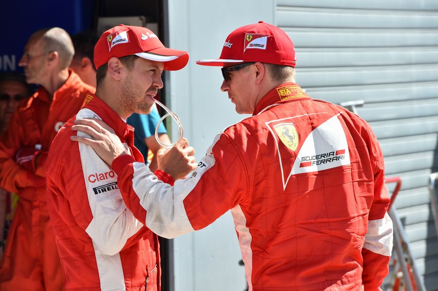 Sebastian Vettel and Kimi Raikkonen chat in parc ferme after qualifying