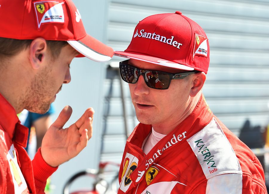 Kimi Raikkonen chats with Sebastian Vettel in parc ferme after qualifying
