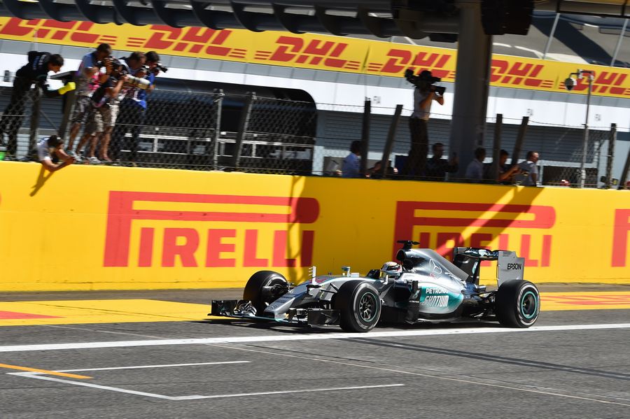 Race winner Lewis Hamilton takes the chequered flag