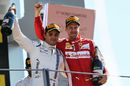 Sebastian Vettel and Felipe Massa celebrate on the podium with champagne