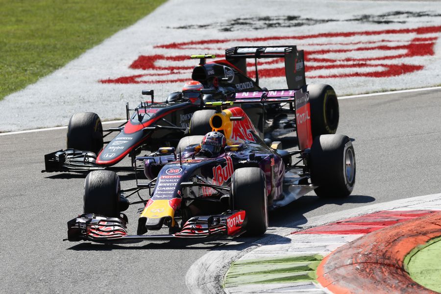 Daniil Kvyat battles a position with Jenson Button