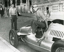 Tazio Nuvolari climbs out of his Auto Union after winning the Belgrade Grand Prix
