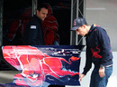 Sebastien Buemi inspects a piece of his Toro Rosso's bodywork