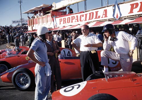 Phil Hill, Luigi Bazzi, Carlo Chiti and Dan Gurney with the Ferraris in the pits during the Portuguese Grand Prix