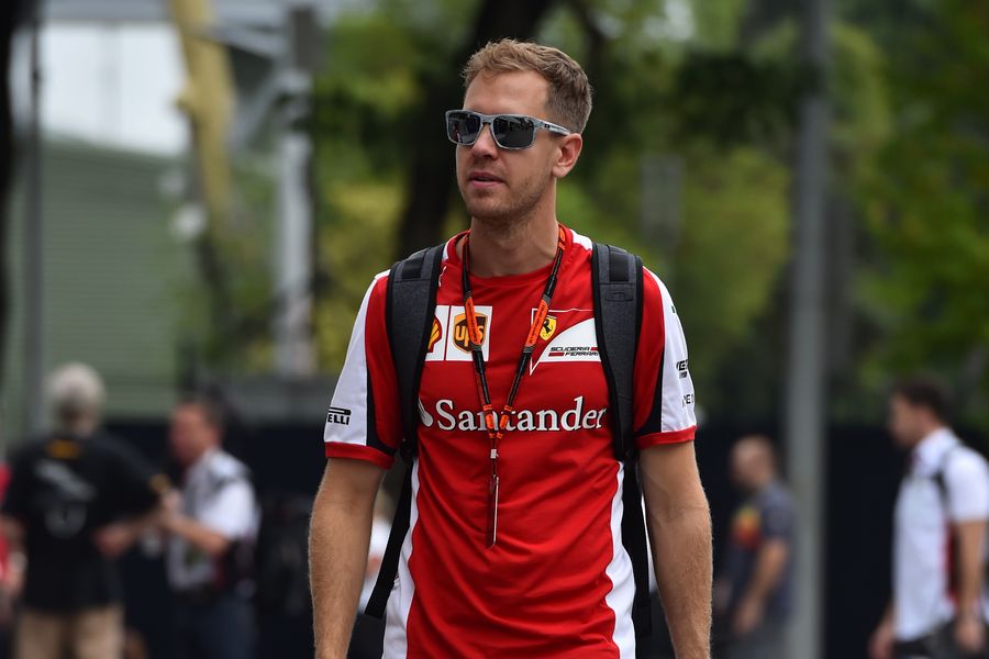 Sebastian Vettel arrives at the paddock