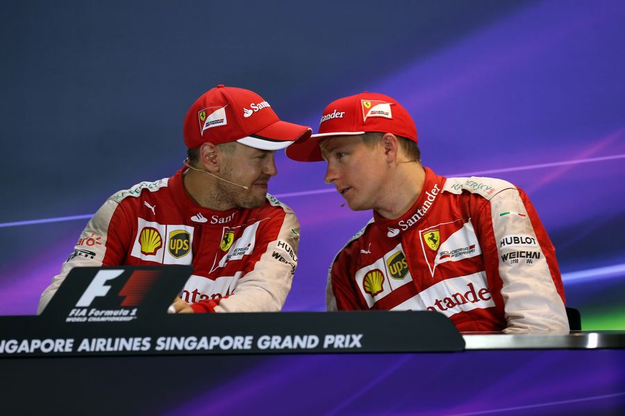 Sebastian Vettel and Kimi Raikkonen chat in the press conference