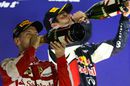 Sebastian Vettel and Daniel Ricciardo celebrate on the podium with champagne