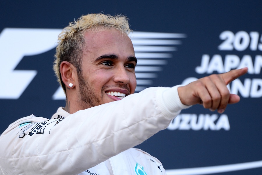 Lewis Hamilton celebrates his win on the podium