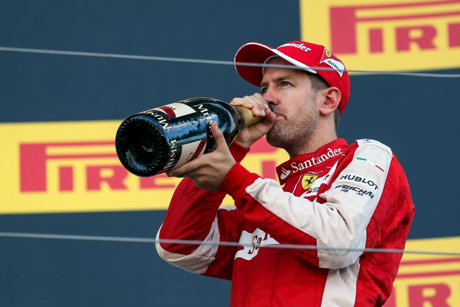 Sebastian Vettel celebrates with champagne