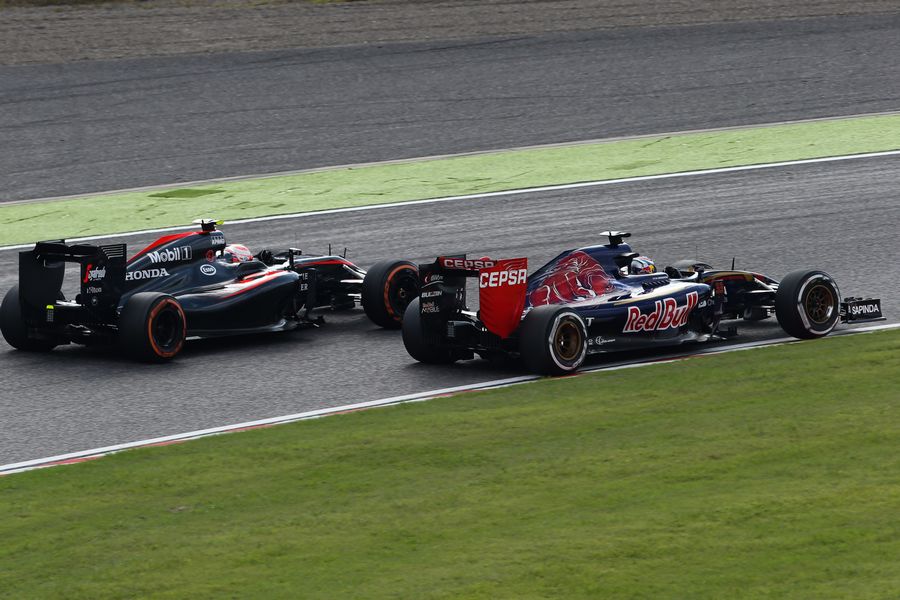Max Verstappen and Jenson Button battle for a position