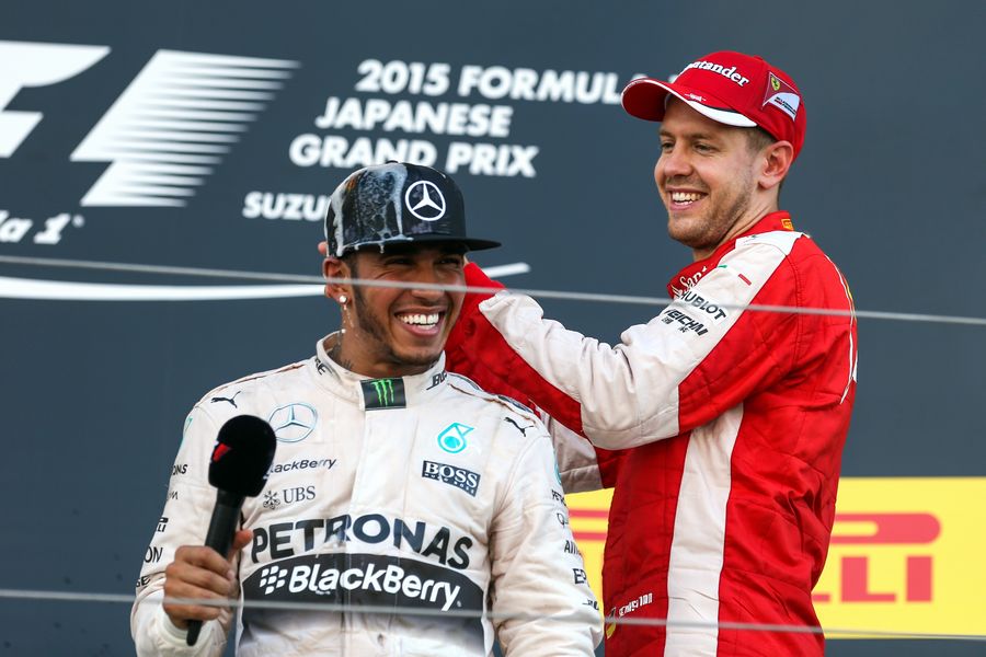 Sebastian Vettel celebrate Lewis Hamilton with champagne on the podium