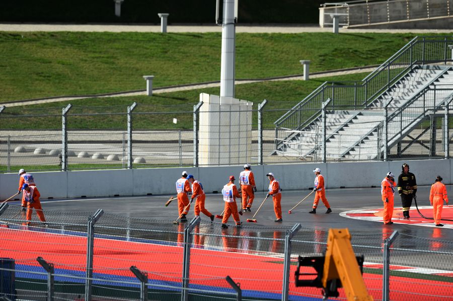 Marshals clean the track where the 