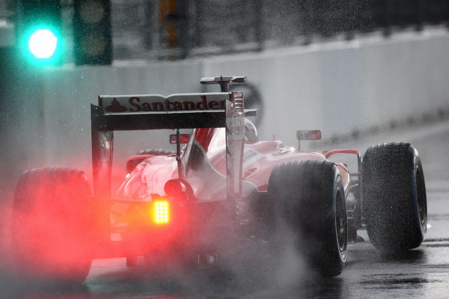 Sebastian Vettel leaves the pit exit on wet track