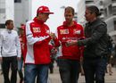 Kimi Raikkonen and Sebastian Vettel sign autographs for a fan