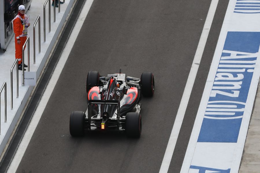 Fernando Alonso makes his way down the pit lane