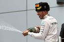 Lewis Hamilton celebrates his win with champagne